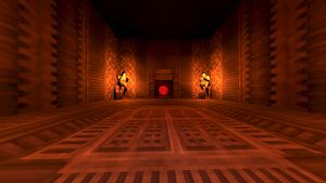 An empty room with Cerberus statues. At the back sits a gate leading to a small room with a Blood Orb.