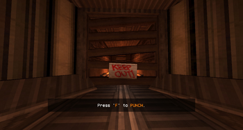 A gray room with a hallway in the middle. The hallway is boarded up with wooden planks, with a sign reading "KEEP OUT!" posted onto the wooden planks.